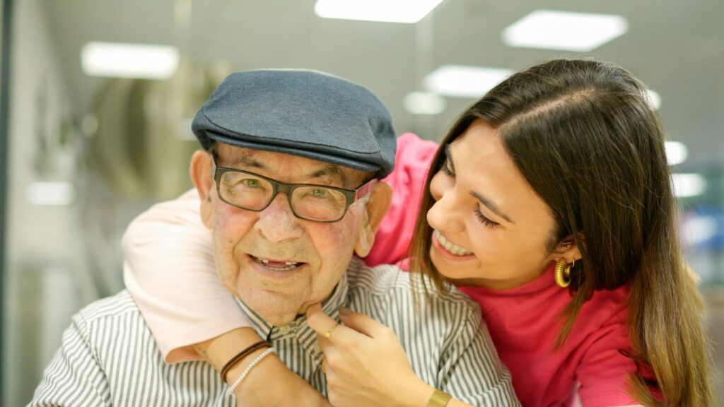 Kind nurse embracing a senior man in a nursing home